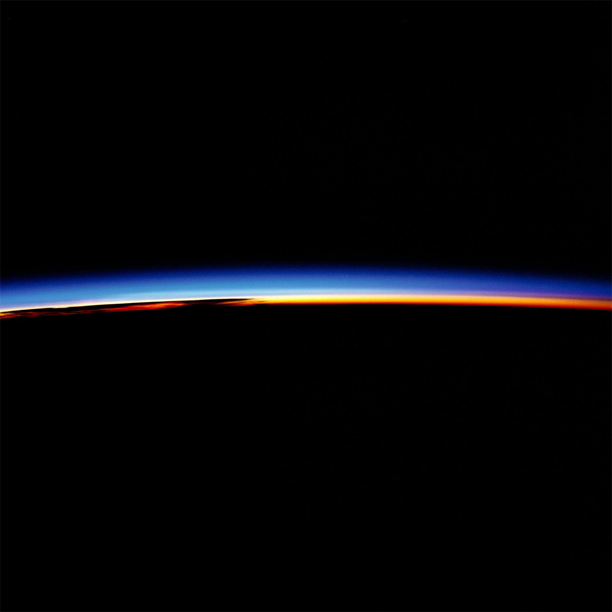 Oct 1984—Space Shuttle (Challenger) astronauts in orbit experienced sunrise every 90 minutes. The bands of colour represent the various layers of aerosol which surround the planet. The brilliant red is the atmosphere; the overlap between red and blue is the stratosphere; the blue layer is the ionosphere. (NASA)